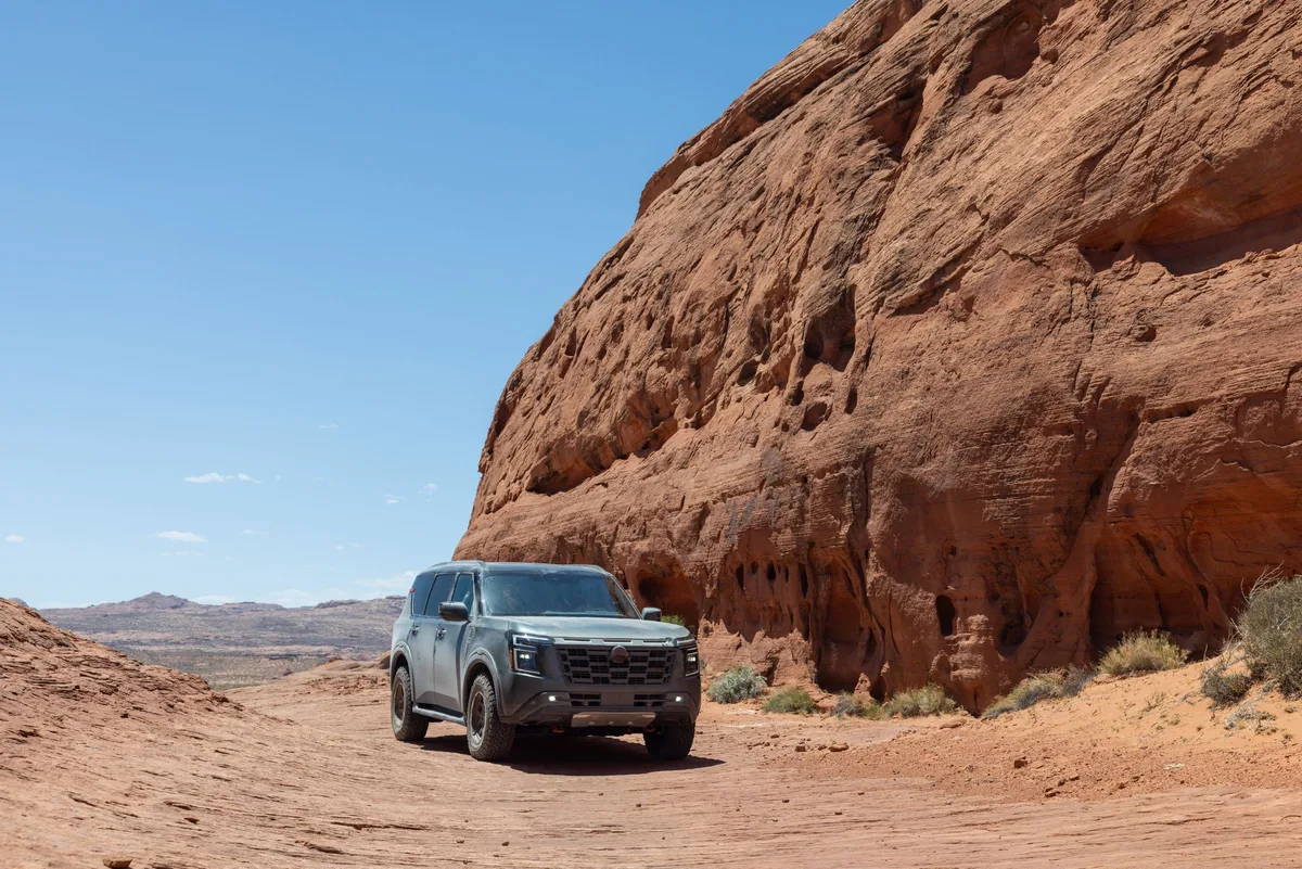 Nissan Armada PRO-4X beside red rock cliffs