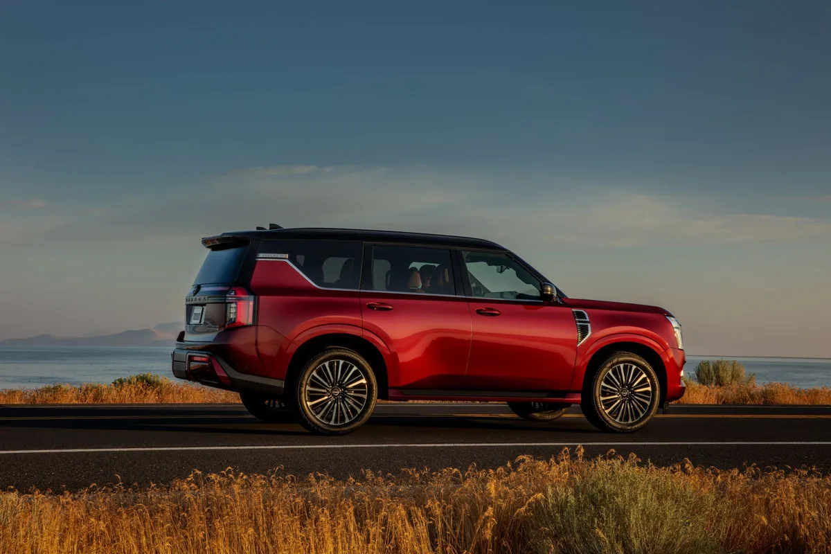 Nissan Armada in red, side view by the coast