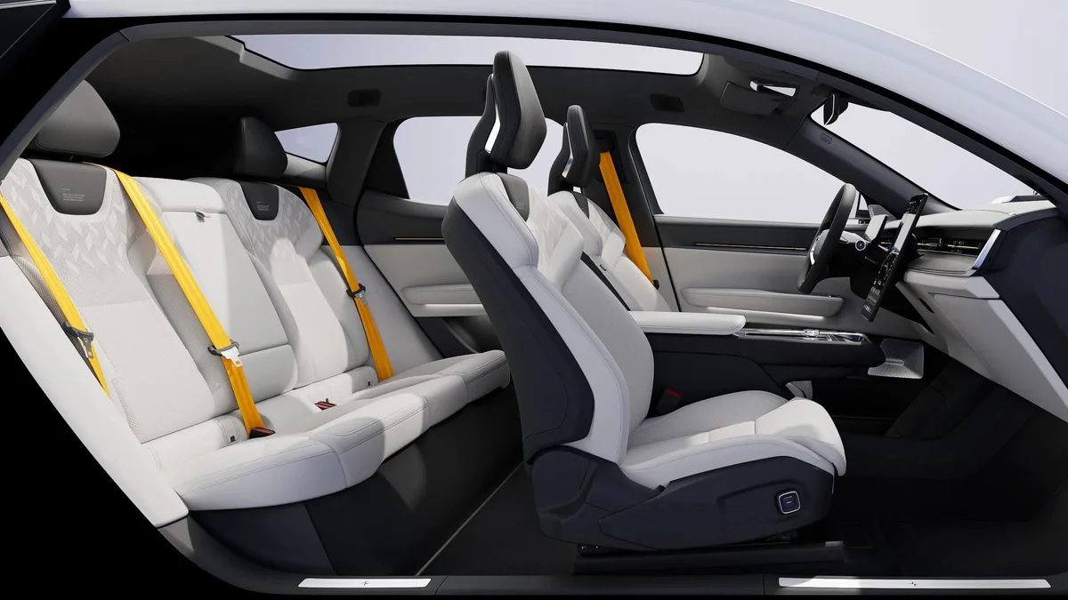 Polestar 3 cabin with light upholstery and gold seat belts