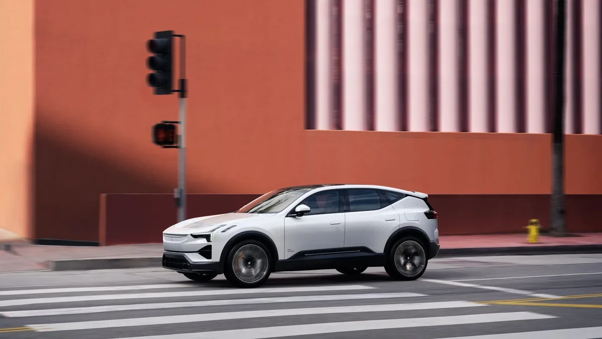 Polestar 3 in white driving through a crosswalk, side profile