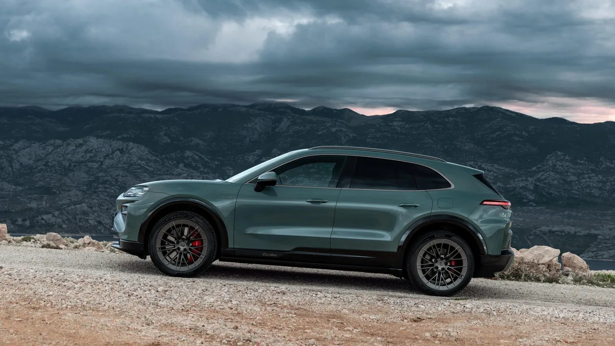 Porsche Cayenne Electric side three-quarter by the sea
