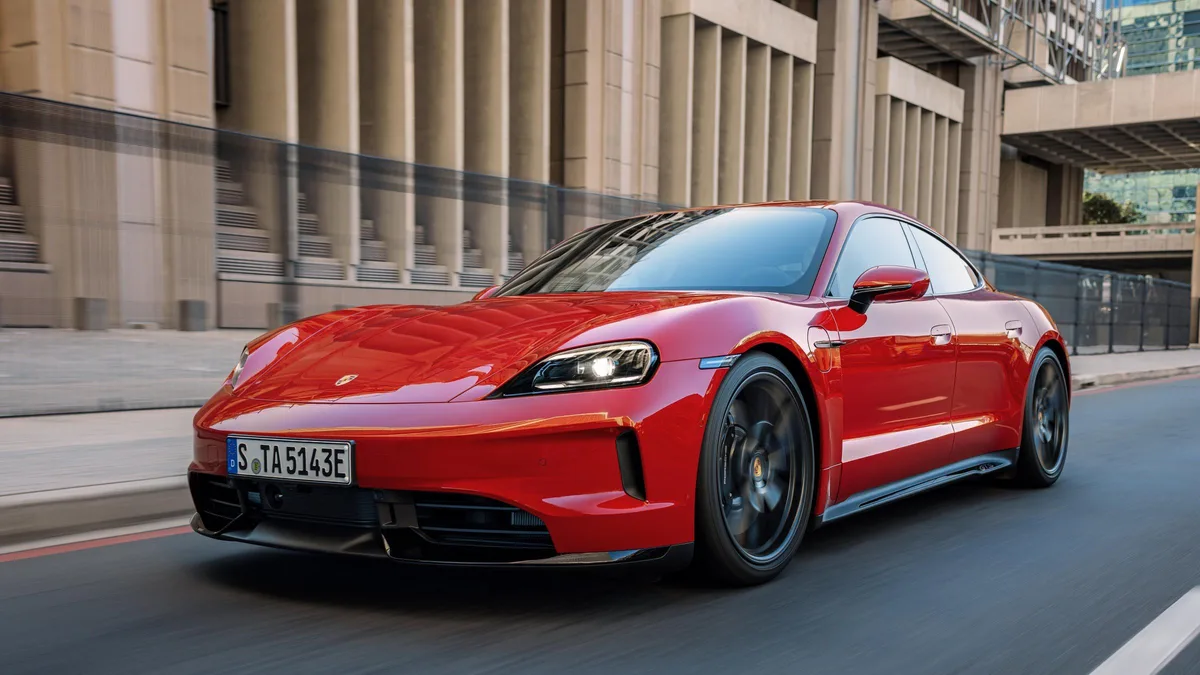 Porsche Taycan driving front three-quarter