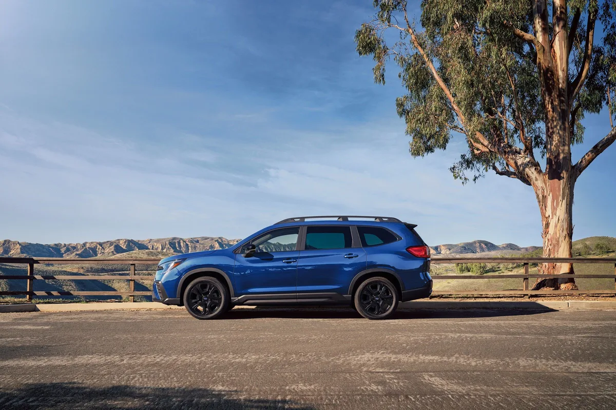 Subaru Ascent in blue parked by a fence, side view